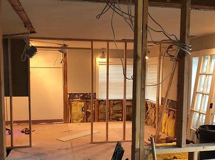 Home renovation project focusing on framed walls and exposed electrical wiring.